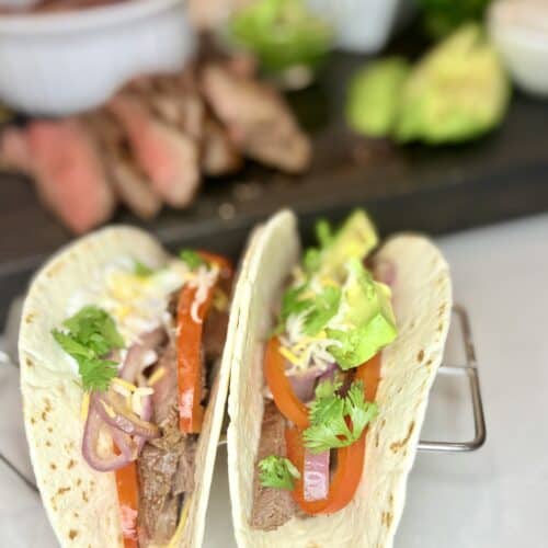 two steak fajitas with toppings