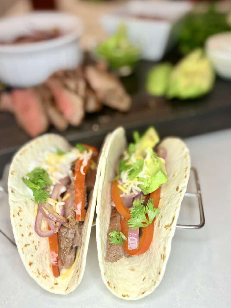 two steak fajitas with toppings