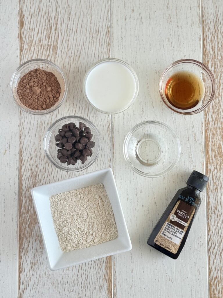 ingredients for muffin in a mug in bowls on a board