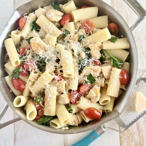 Cooked chicken and pasta in a skillet