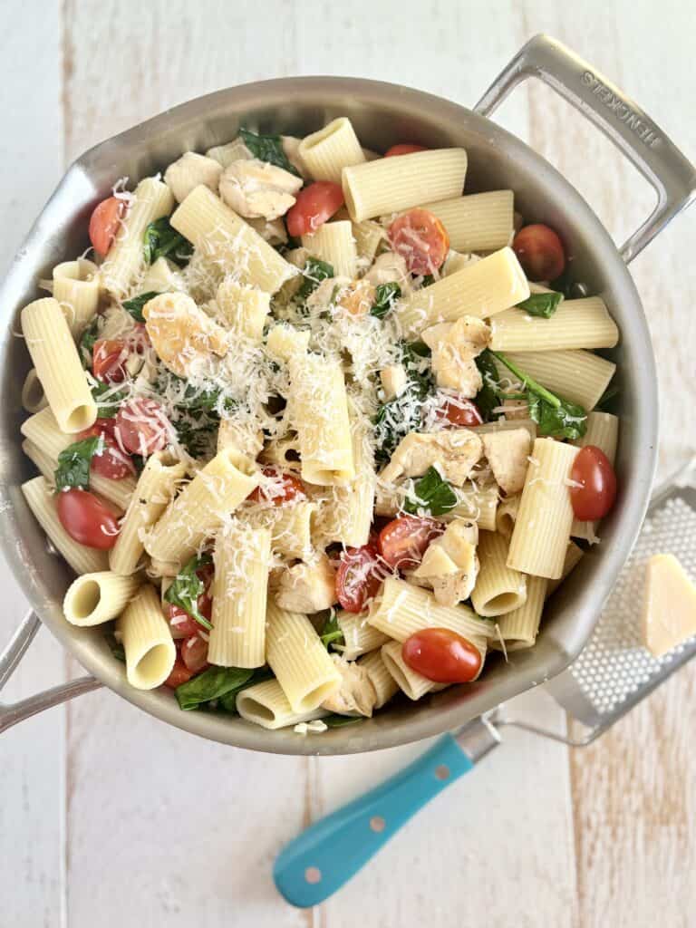 Cooked chicken and pasta in a skillet