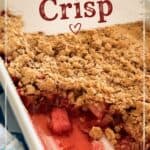 Strawberry crisp dessert with a crumbly topping and fresh strawberries in a white baking dish, served with a spoon, perfect for a sweet, fruity treat.
