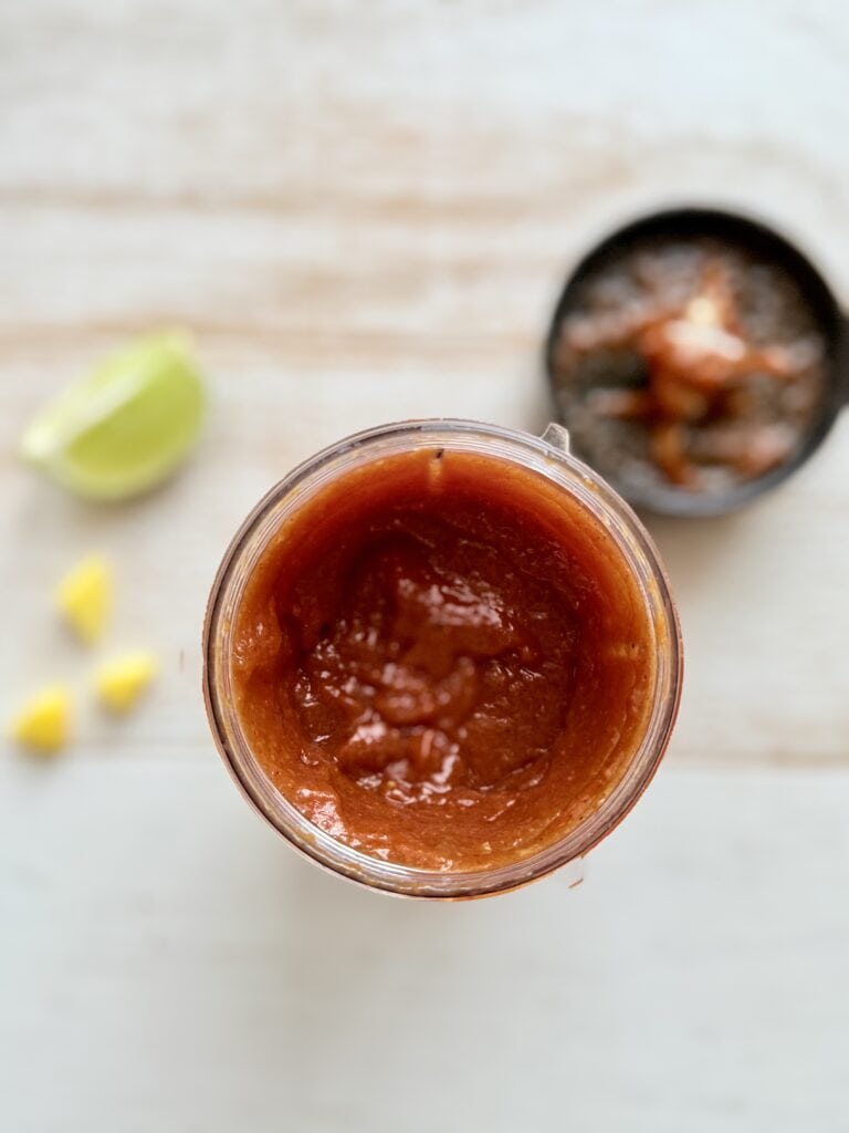 Blended ingredients in a plastic cup on the counter.