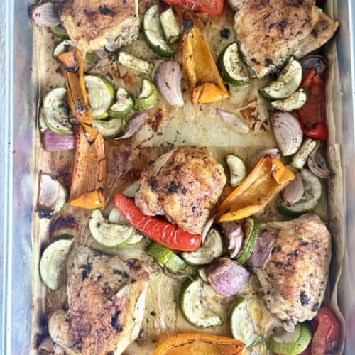 cooked jerk chicken and veggies on a sheet pan