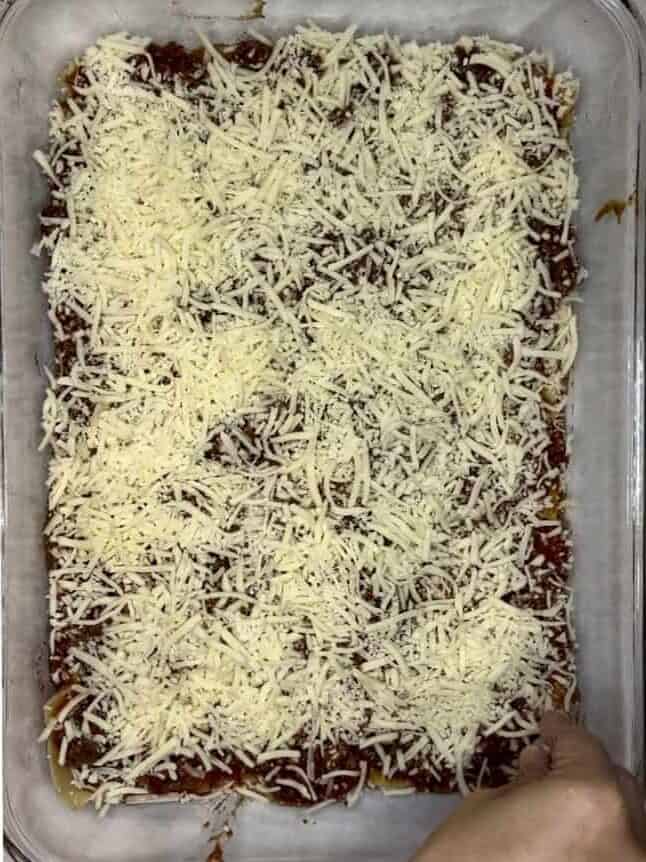 Cheese-covered homemade baked lasagna in a glass dish.