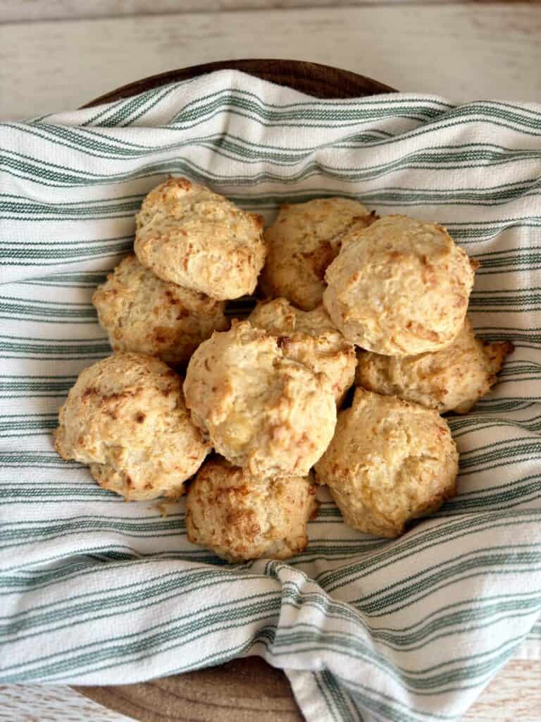 drop biscuits on a towel in a wooden bowl