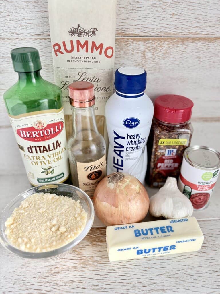 Ingredients for pasta alla vodka on a wooden counter