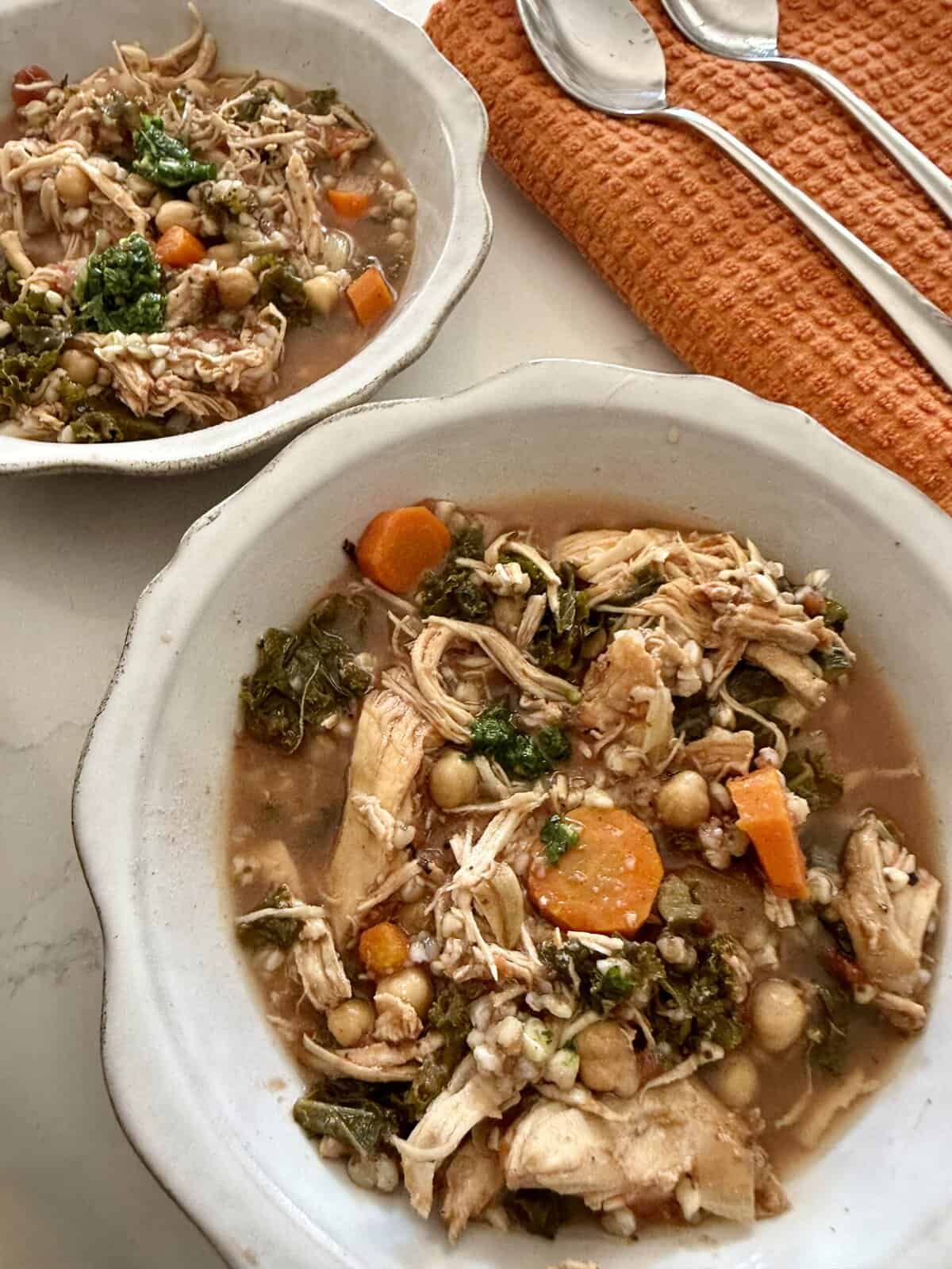 Tender chicken and vegetable soup with chickpeas, carrots, and leafy greens in a comforting broth, perfect for easy homemade meals and nourishing family dinners.