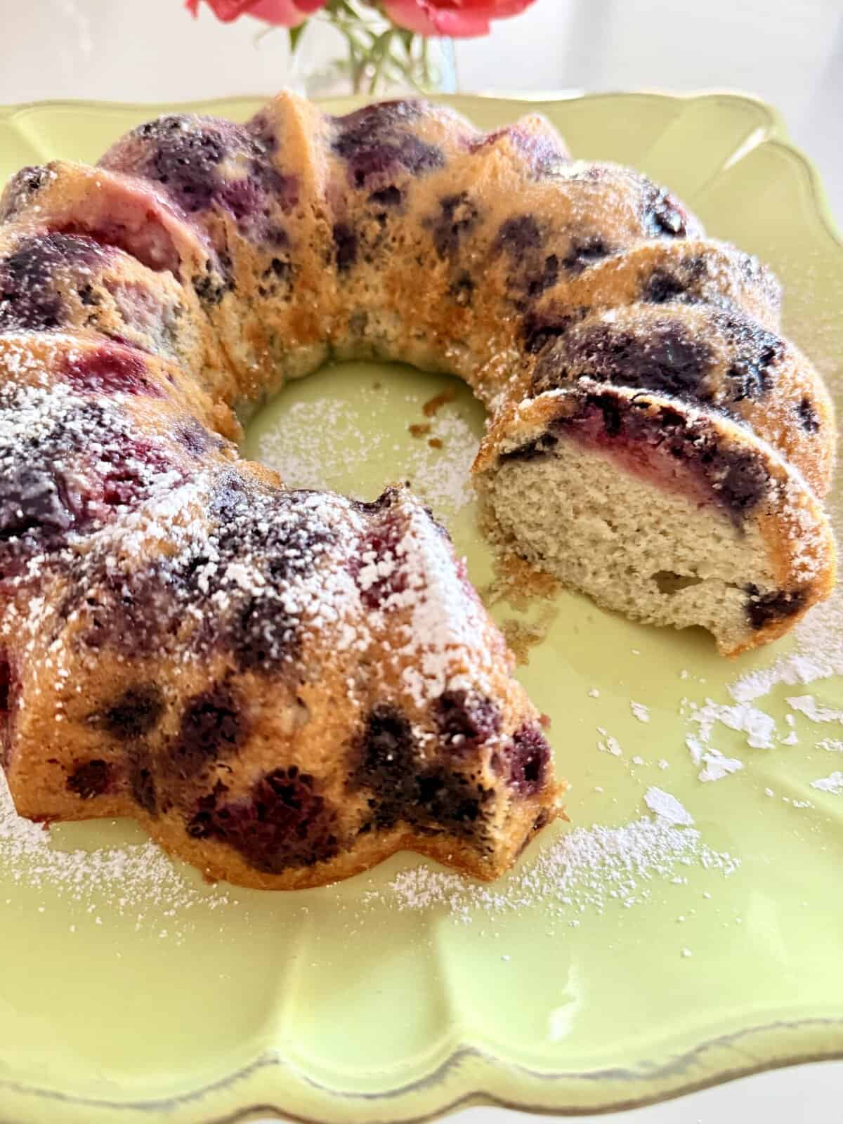 Filled Bundt cake with a moist texture, topped with powdered sugar, perfect for dessert or special occasions. Made with fresh berries and a rich, buttery batter.