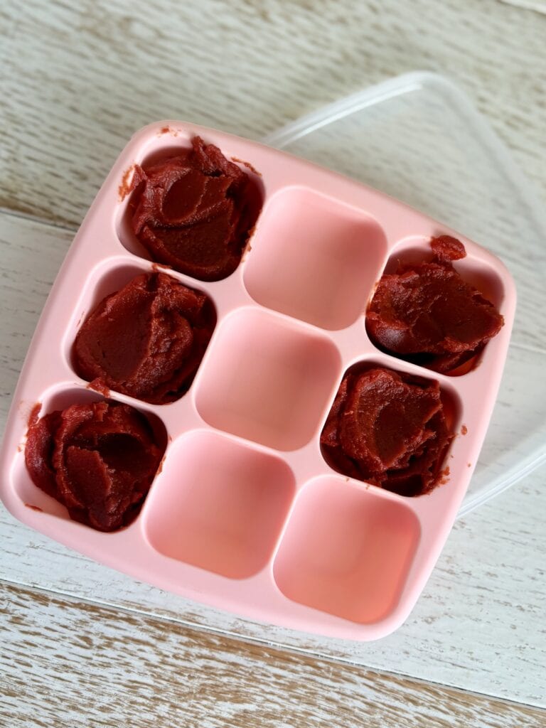 Leftover tomato paste in a pink silicone mold, perfect for freezing. 