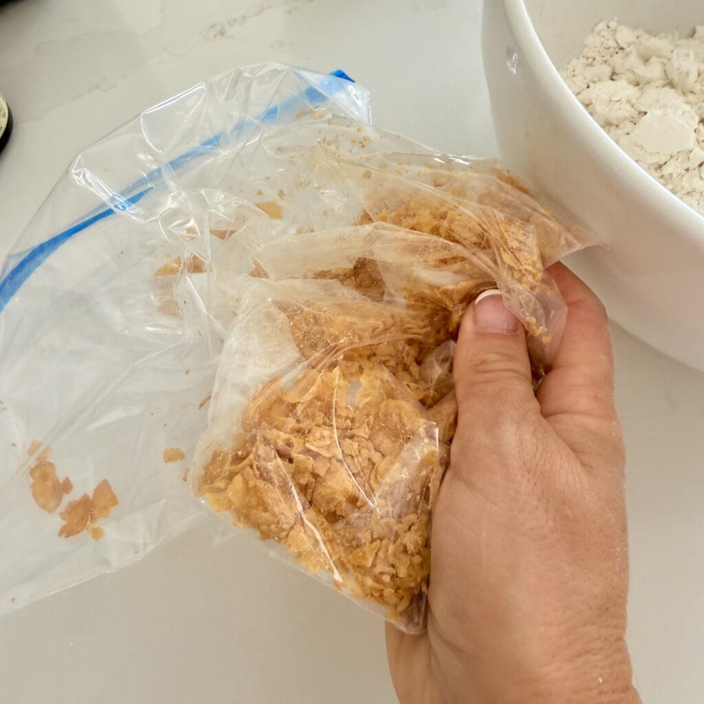 Using my hand to crush corn flakes in a Ziploc bag
