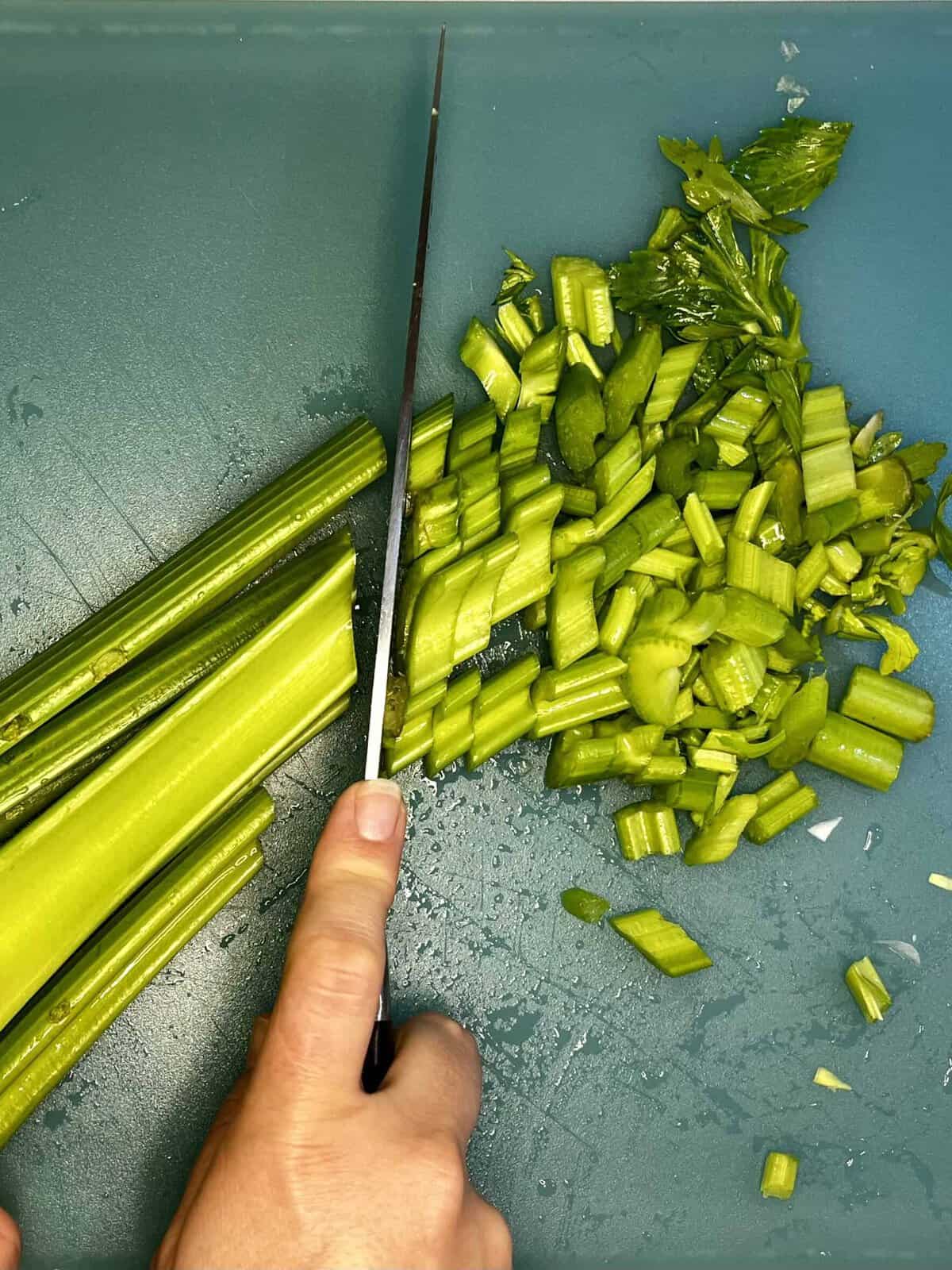 celery being sliced with a knife