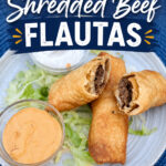 Shredded Beef Flautas on a bed of lettuce with small bowls of sour cream and salsa con queso