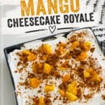 Creamy mango cheesecake royale topped with fresh mango chunks and cinnamon crumble, served on a white plate. Perfect for a quick, delicious dessert recipe from Simply Made Dish.