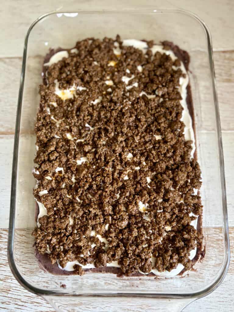 A glass baking dish filled with a layered taco dip