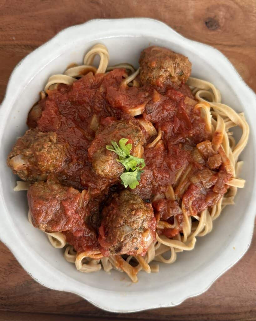 Easy Linguine and Meatballs for two in a grey plate on a brown tray.