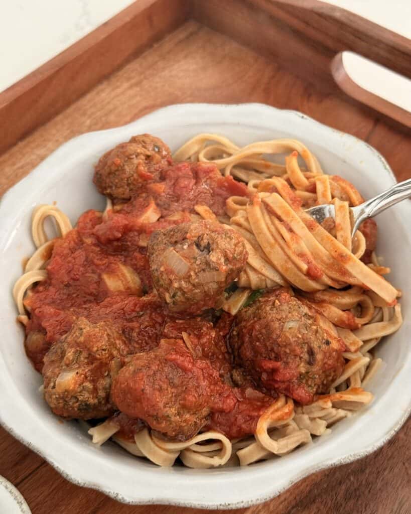 Easy Linguine and Meatballs for two in a grey plate on a brown tray