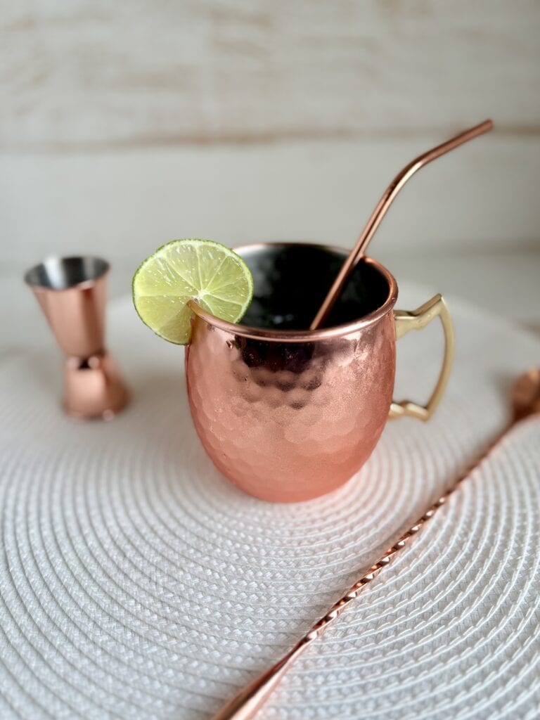 Moscow Mule in a copper mug garnished with a lime wedge.