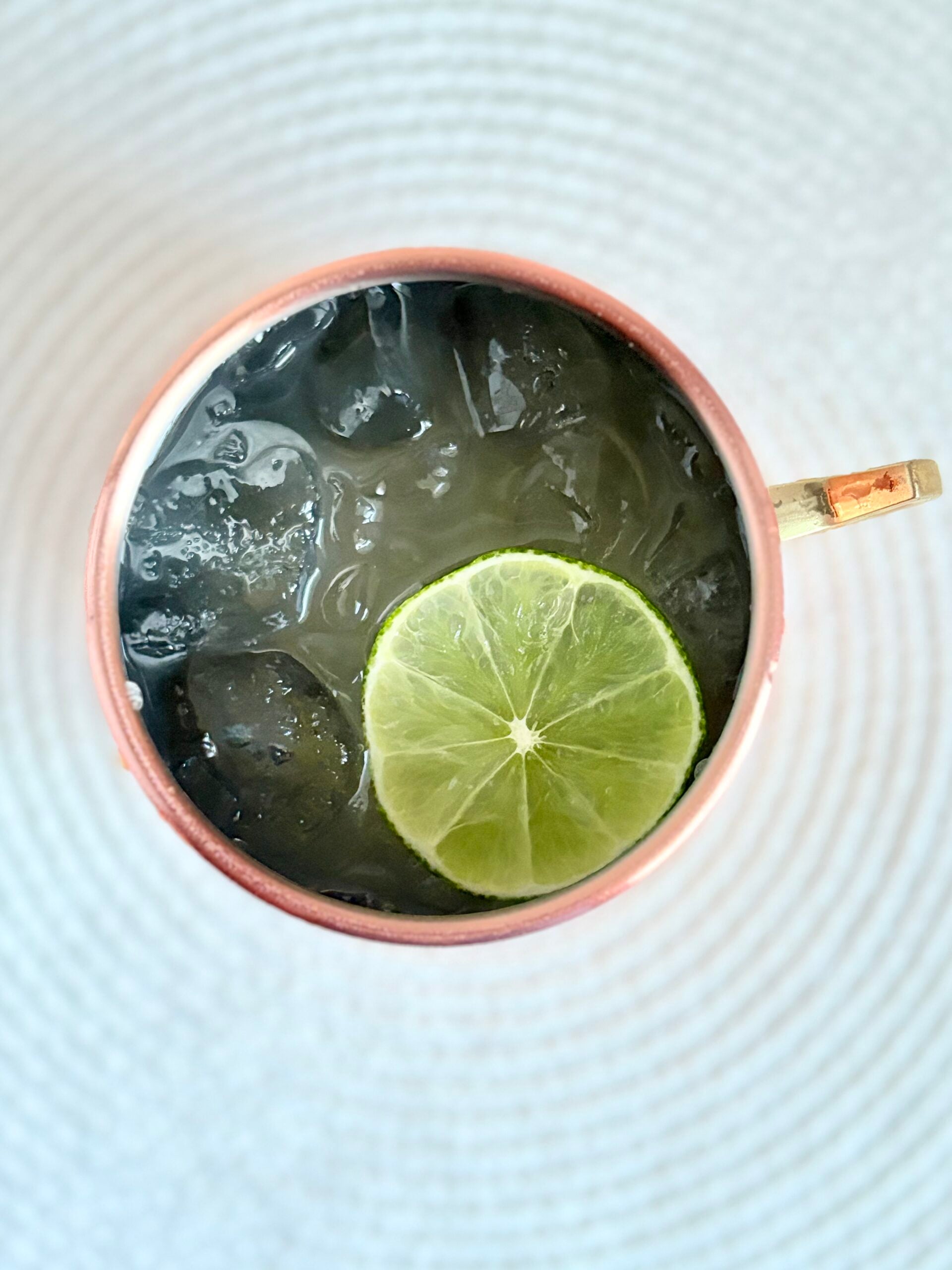Moscow Mule garnished with lime served in a copper mug