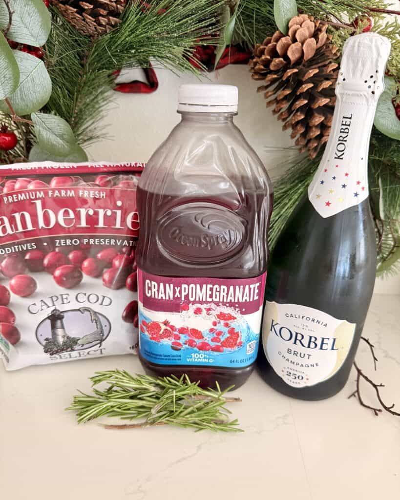 Fresh cranberry pomegranate juice, sparkling champagne, and cranberry preserves for holiday cocktail.