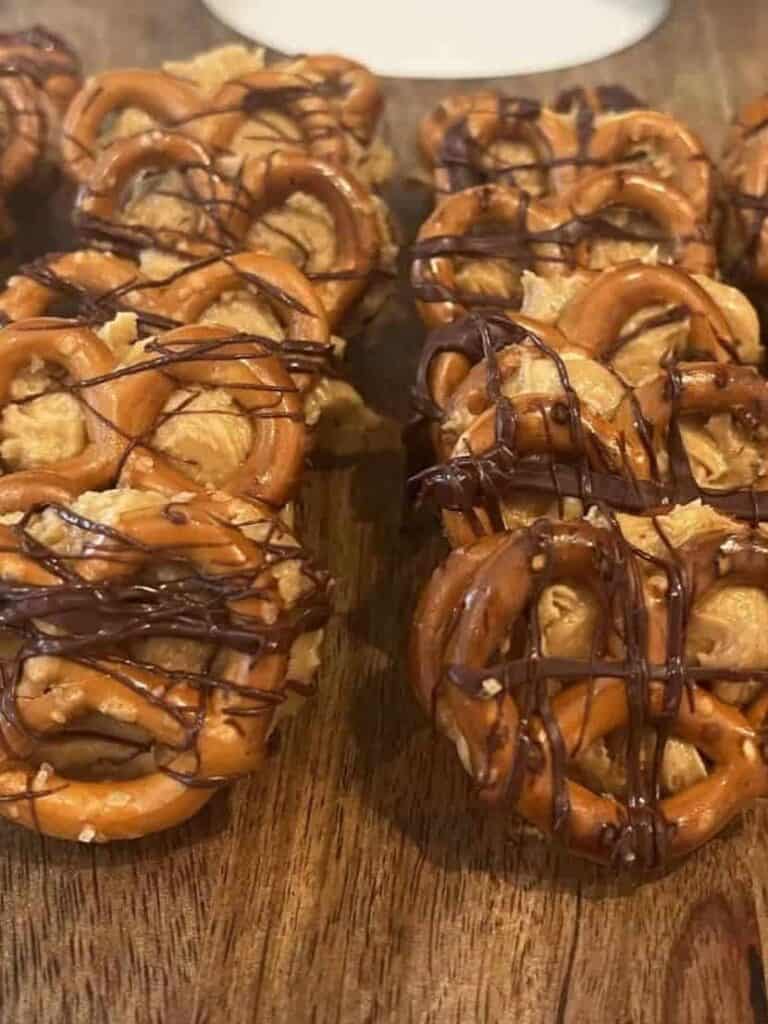 Chocolate Pretzel bites on a wooden serving board.